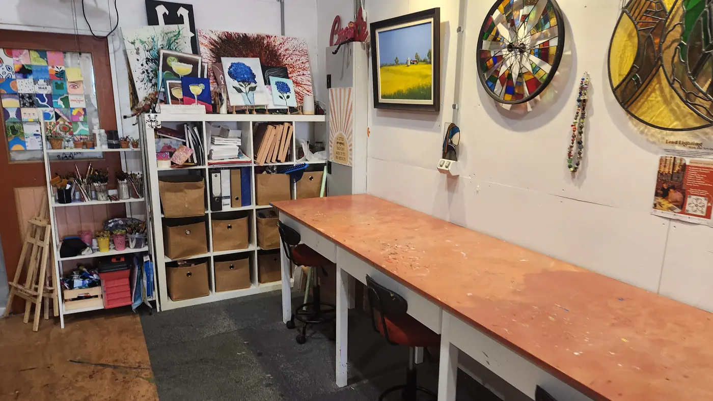 Art studio workbench and storage shelves inside Social Co House